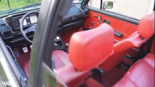 Red VW GTI Mk1 car interior with sporty seats and pedals