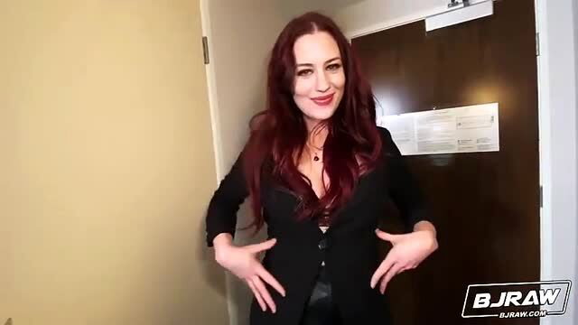 Busty redhead Jessica Ryan in sexy black blazer cleavage tease