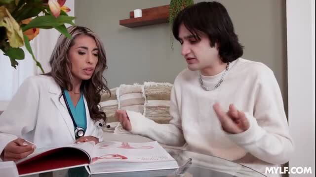 Luna Star as doctor examines patient with anatomy book in sexy consultation