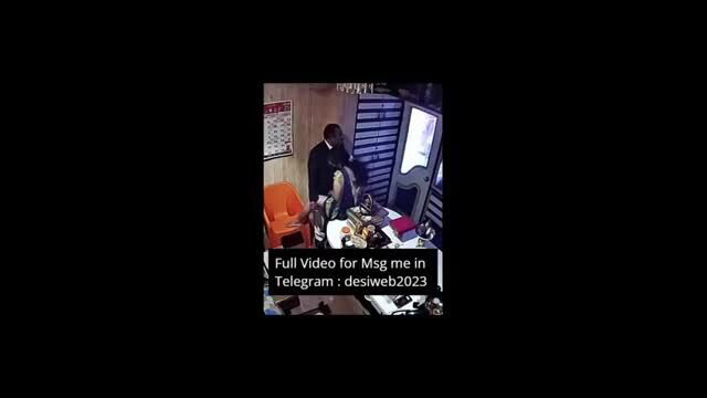 Desi man in suit over desk with cash in office CCTV spy cam