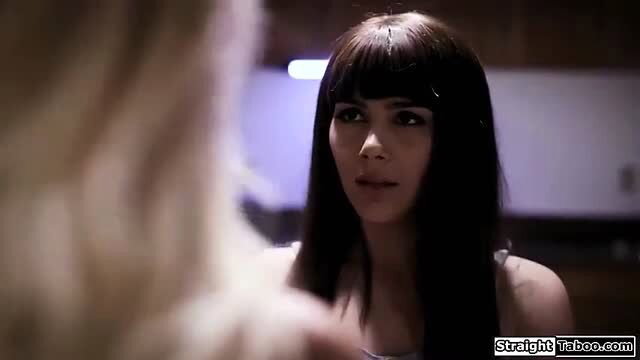 Busty brunette MILF in tank top stares intensely in taboo scene