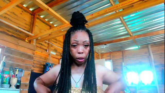 Ebony woman with braids tries on sexy gold costume from fan