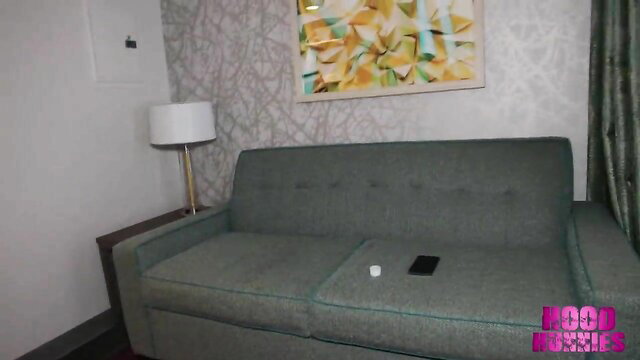 Hotel room sofa with phone and pillow, Hood Bunnies watermark
