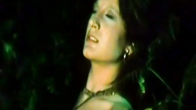 Vintage retro brunette with big tits in green jungle ecstasy closeup