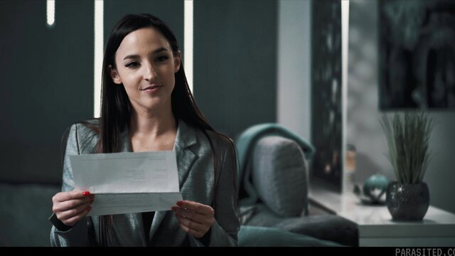 Amirah Adara in sexy silver blazer holding letter, teasing gaze