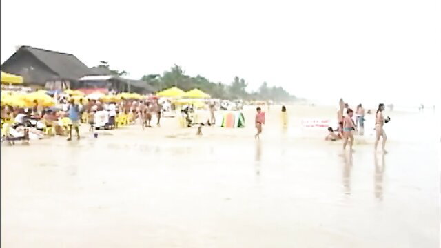 Brazilian beach crowd with women in bikinis at Ilheus