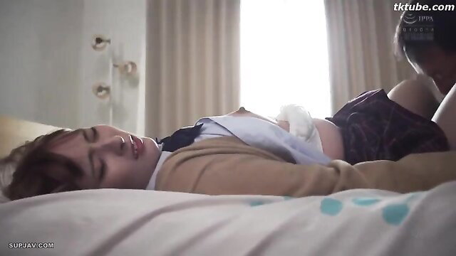 Kanon Ibuki in school uniform, lying seductively on bed in JAV stepdad scene