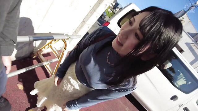 Japanese woman in skirt smiling at POV camera outdoors, JAV intercrural tease