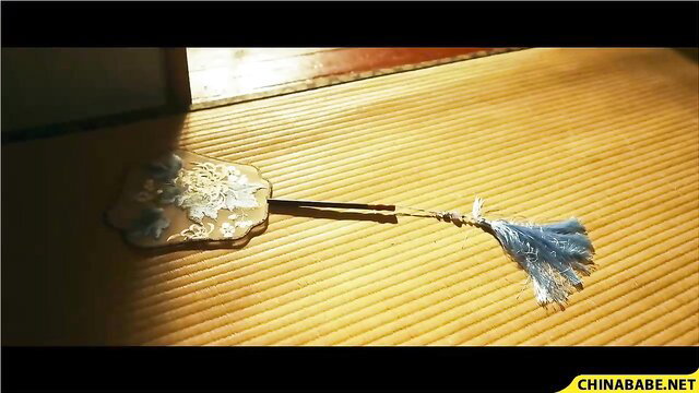 Elegant Asian wife with ornate fan on tatami, JAV tease