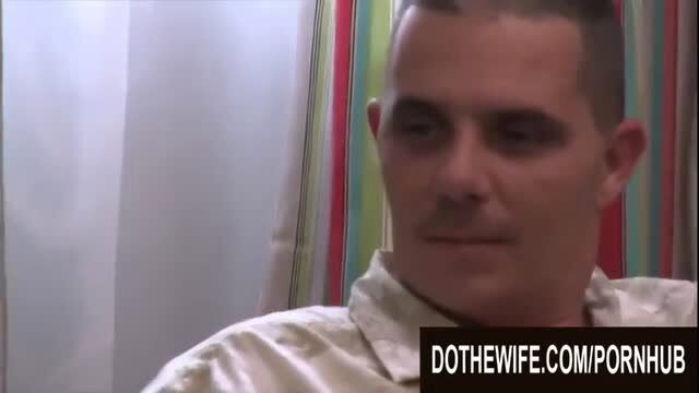 Man with buzzcut in white shirt in hotwife bedroom scene