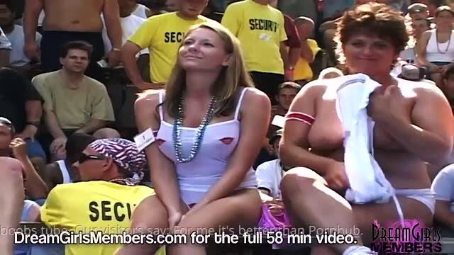 Blonde busty wife flashes tits with curvy MILF at wild crowd event