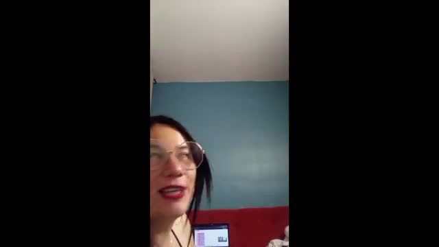 MIICHELLENATA closeup face with glasses and red lips in amateur video