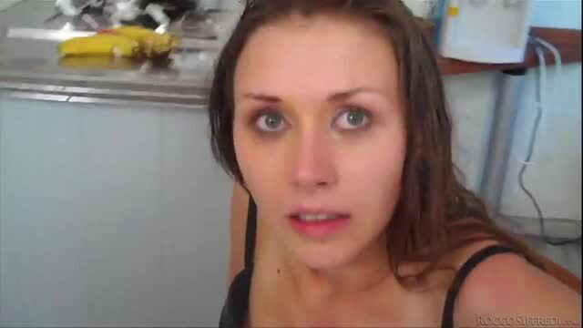 Brunette in black lingerie with wide eyes in kitchen, bubble butt tease