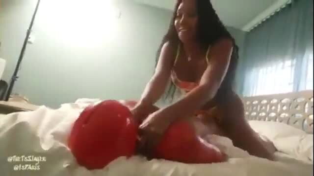 Huge Cock Black Tgirl in lingerie squeezing red balls on bed