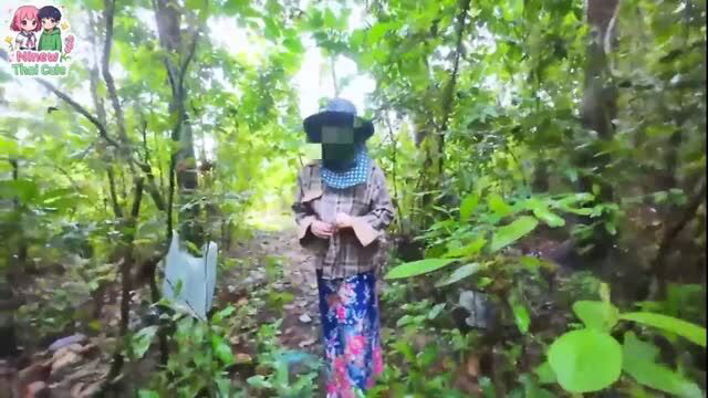 Thai woman outdoors in forest wearing hat and plaid shirt