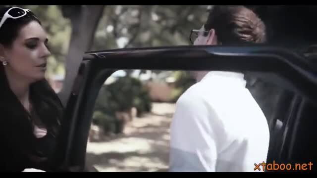 Kenna James in black top by car with older woman