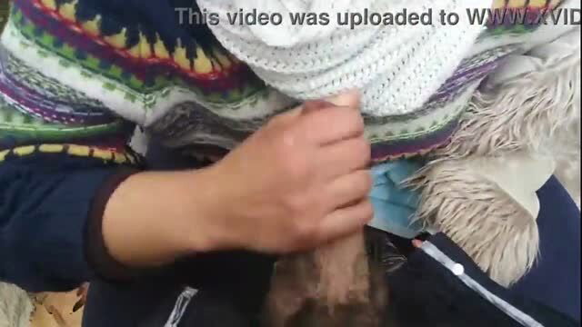 Outdoor blowjob in the park with person in sweater holding penis