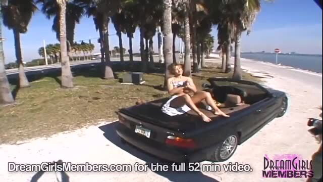 Hot MILF Mindy teases in a convertible by the beach