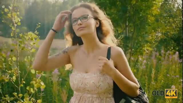 Young woman in sheer dress outdoors teases older man