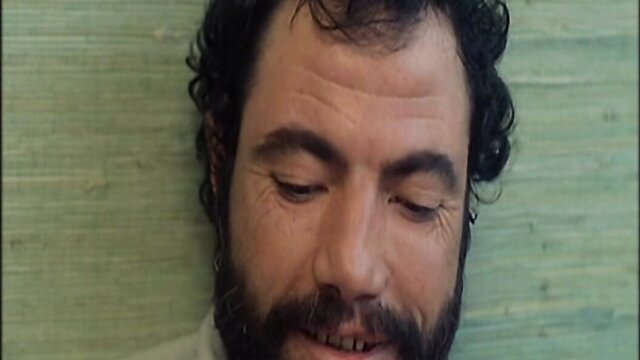 Closeup of mature bearded man's intense face in erotic scene