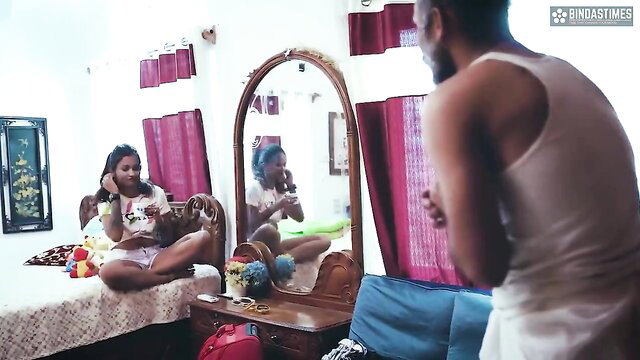 Indian granddaughter in tank top & shorts sits legs spread as grandpa watches