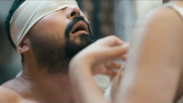 Blindfolded bearded Arab man gropes woman's shoulder in steamy intimate scene