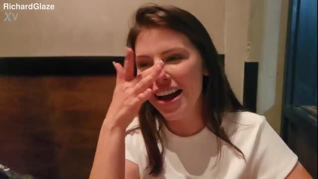 Adriana Chechik laughing and posing with hand near face