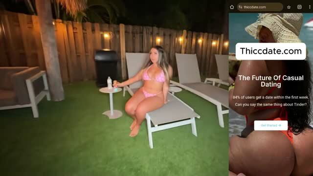 Curvy woman in pink bikini on lounge chair at night