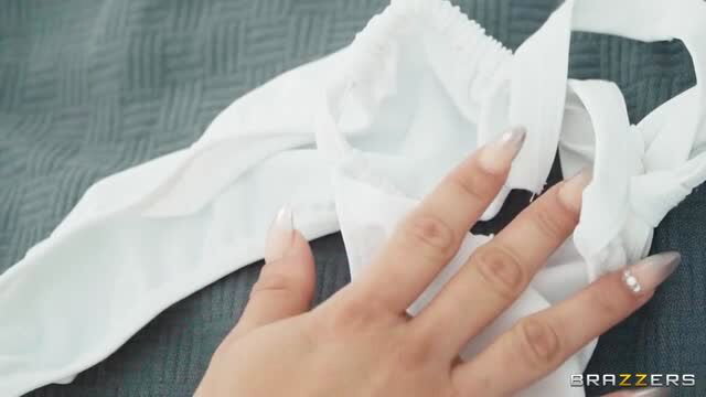 Sara Retali holding white lingerie on bed, Brazzers trophy wife