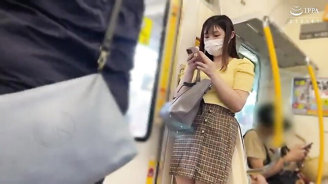 Asian JAV girl in yellow top and plaid skirt on crowded subway, upskirt tease