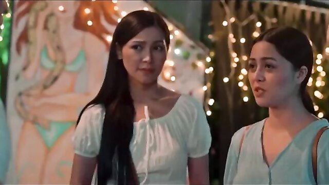 Two sexy Asian women in white and teal dresses at festive outdoor party