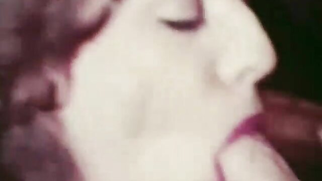 Closeup of pale woman with red lips licking erect cock intensely