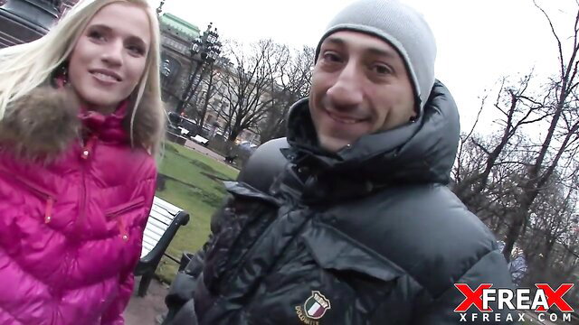 Blonde Linda Babe with guy in park, pink puffer jacket winter outdoor