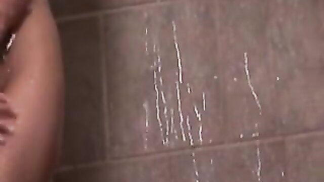 Busty woman showering with cum on tiles in orgy sex party