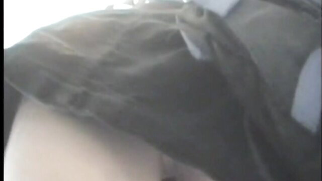 Blurry spy cam upskirt view of woman's pale thighs and panties in car