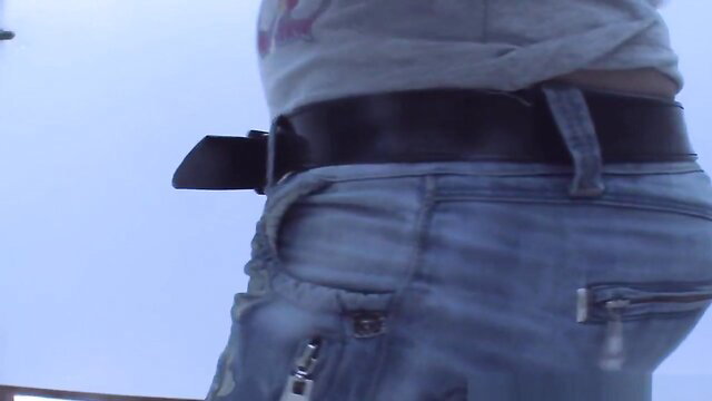 Amateur spy cam of curvy woman in tight jeans and belt in beach changing room