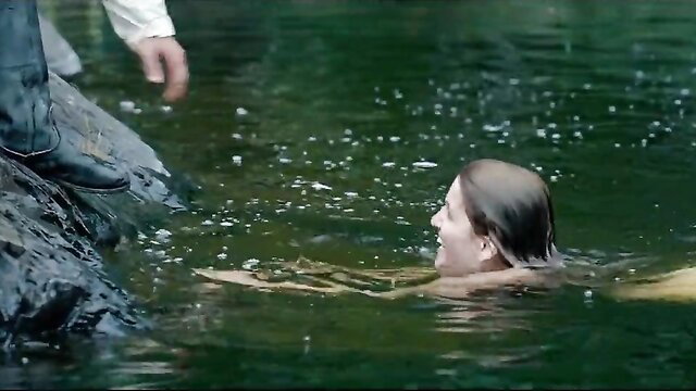 Nude mermaid with wet brunette hair grabbed by man in historical Nazi-era scene