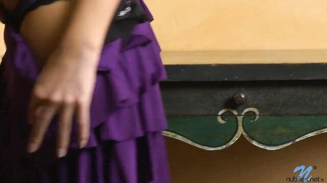 Caprice Capone in sexy purple evening dress, teasing pose