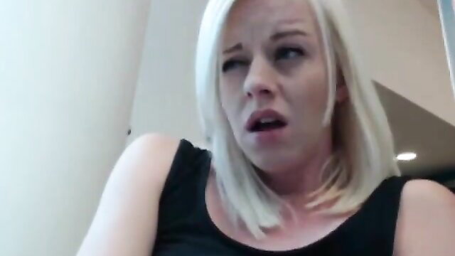 Blonde woman with shocked expression in tight tank top closeup