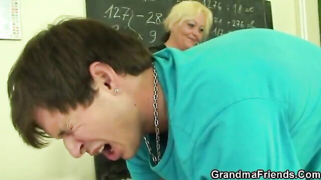 Old blonde teacher facefucks young guy in classroom threesome