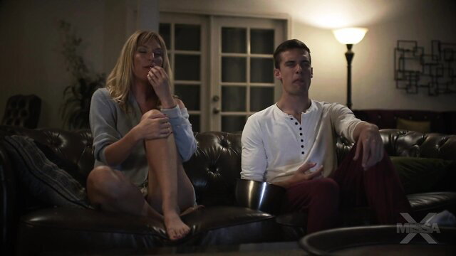 Mona Wales blonde MILF in off-shoulder top with handsome man on couch