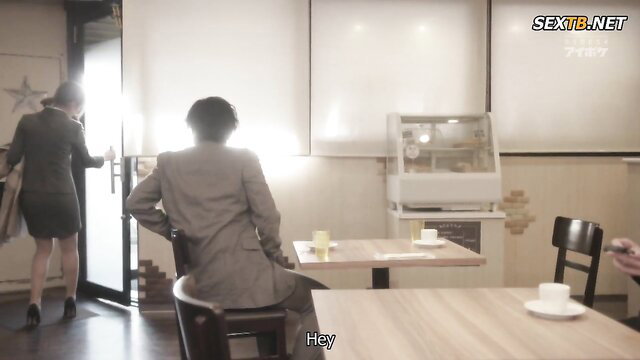 Asian office couple in tight skirt suit at cafe table