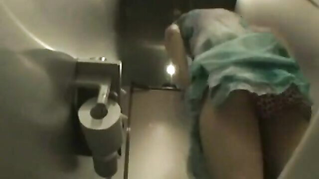 Asian woman bent over in cabaret club toilet, upskirt panties view