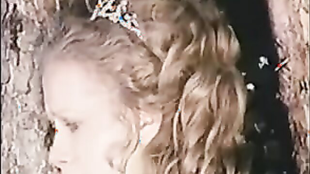 Connie Booth blonde teen closeup profile in tree hollow, curls and tiara