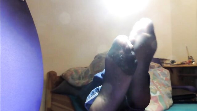 Closeup of sexy nylon stockings feet soles, arched toes