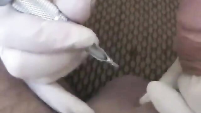 Granny Doctor Melanie in white gloves examines hard dick closeup