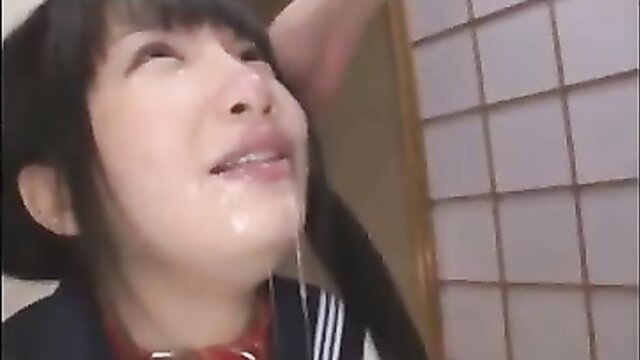 Japanese schoolgirl in sailor uniform with cum dripping from open mouth after deepthroat