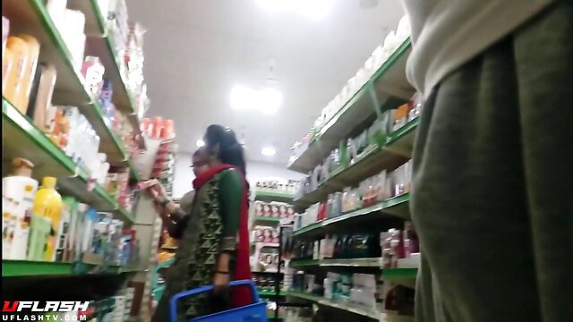 Indian woman in green saree shopping in store, bulge watch tease