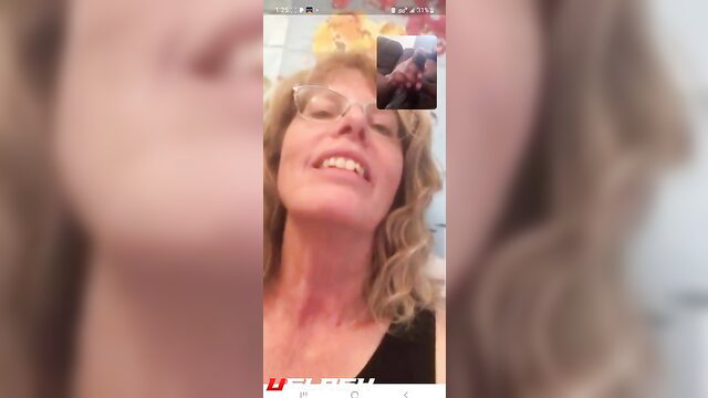 Mature blonde tutor smiles in video call, hand flash with BBC cum