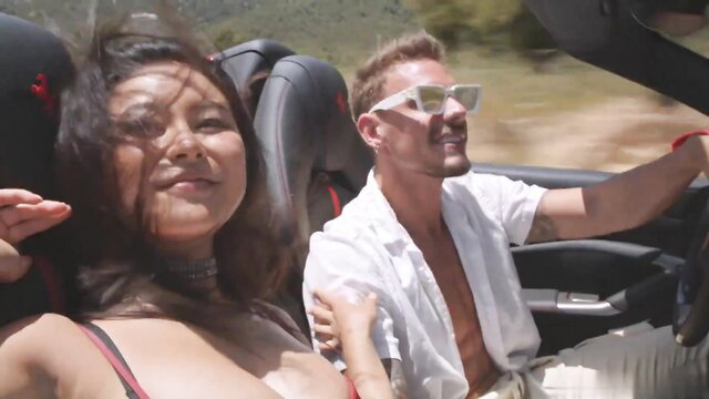 Rae Lil Black in sunny car ride with hot guy, cleavage out